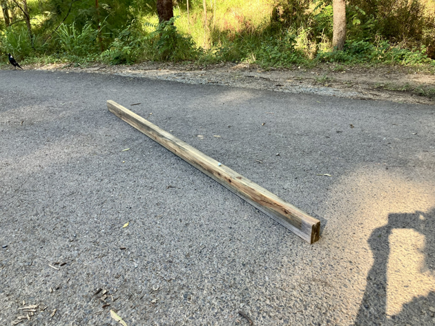 A piece of timber laid out on a bitumen road. It's 45mm by 90mm by 2400mm.